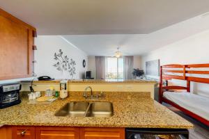a kitchen with a sink and a bed in a room at Waterscape B630 in Fort Walton Beach