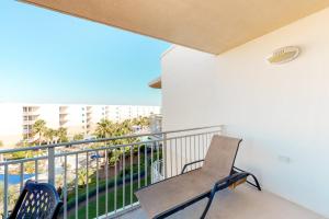 a balcony with a chair and a view of the ocean at Waterscape B630 in Fort Walton Beach