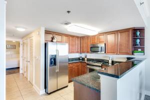a kitchen with wooden cabinets and a stainless steel refrigerator at Waterscape B628 in Fort Walton Beach