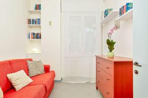 a living room with a red couch and a red dresser at Lerici 5 Terre casa il Bivio 1989 in Lerici