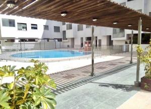 basen zewnętrzny w budynku z markizą w obiekcie Apartamento nuevo con piscina, temporada w mieście El Puerto de Santa María