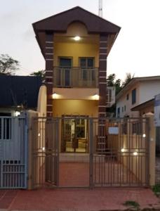 a house with a gate in front of it at Marrets International Hotel - "Express" in Cape Coast