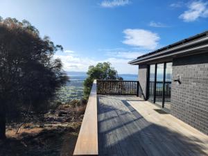 a wooden deck on the side of a house at Mount Rumney Escapes - 4 Seaview Devil House in Mount Rumney