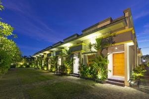 a building with a lot of plants in front of it at The Banyumas Villa in Denpasar +62 photos