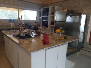 a kitchen with a granite counter top and a refrigerator at RELAX La Tuquita Raco in Raco