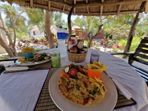 a table with a plate of food and french fries at Asamai Villas 