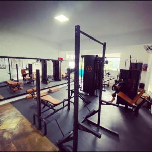 a gym with rows of equipment in a room at Casa Nascimento Vista Panorâmica Serra São José in Tiradentes