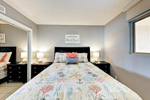 a bedroom with a large bed and two lamps at Inverness #304 in South Padre Island +27 photos