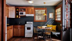 a kitchen with a stove and a table with chairs at Highlands Resort - Adults Only in Guerneville