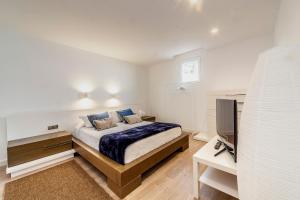 a bedroom with a large bed and a television at Luxury Casa El Marques in Puerto del Carmen +26 photos