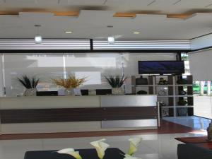 a living room with a bench and a tv at Sumo Asia Hotels - Davao in Davao City