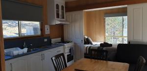 a kitchen with a sink and a kitchen with a bed at Mount Rumney Escapes - 1h Haven Horse House in Mount Rumney