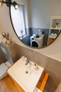 a bathroom with a sink and a mirror at Fine Stuuv in Ratzeburg +4 photos