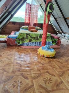 a room with two beds and a wooden floor at Oasis del Tortuguero in Cariari