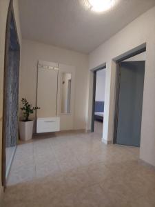 um quarto vazio com uma casa de banho com um espelho e um lavatório em Apartment Povljana 224b em Povljana