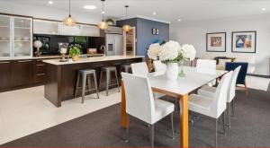a kitchen and dining room with a table and chairs at Idyllic Tui in Picton