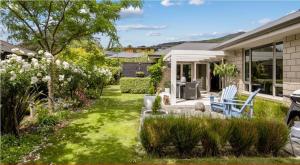 a home with a yard with grass and a house at Idyllic Tui in Picton
