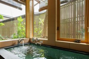 a swimming pool in a building with windows at Machi no Odoriba in Kanazawa