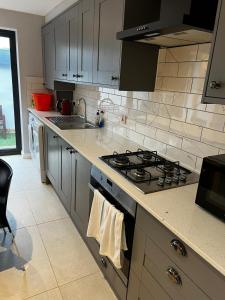 a kitchen with a stove and a counter top at 2b Seymour road in Hackbridge