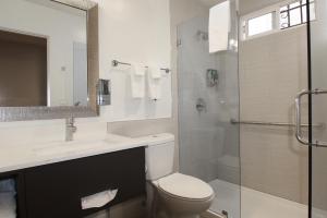 a bathroom with a toilet and a sink and a shower at Hotel 414 Anaheim in Anaheim