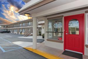 a red door on the side of a building at Hotel 414 Anaheim in Anaheim