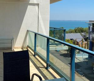 a balcony with a blue railing and a view of the ocean at Sea View Full Apartment at Darwin City Heart in Darwin