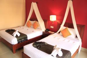 Postel nebo postele na pokoji v ubytování Mekong Angkor Palace Inn