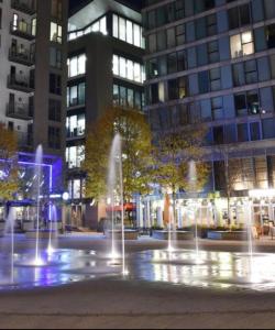 a fountain in the middle of a city at night at Apartment 7 in Milton Keynes