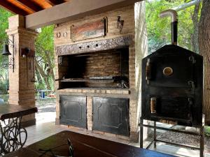 an outdoor kitchen with a large oven in a patio at Finca Lo de Jose in La Banda