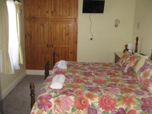 A bed or beds in a room at The Grove Cottages