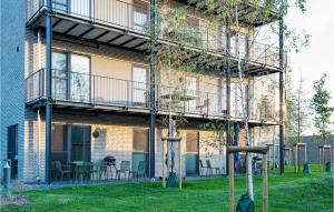 a building with a balcony and tables and chairs at Pet Friendly Apartment in Lembruch