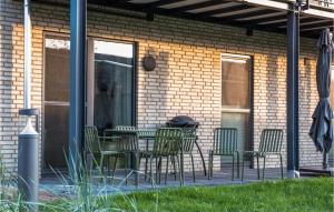 a patio with chairs and a table and a grill at Pet Friendly Apartment in Lembruch