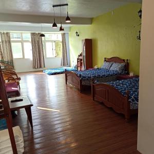 員林的住宿－快樂宿，一间卧室设有两张床,铺有木地板