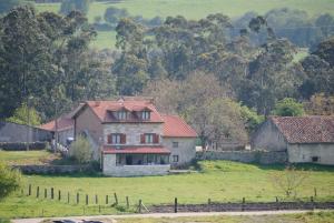 una casa vieja en medio de un campo en Hosteria El Corralucu, en Serdió