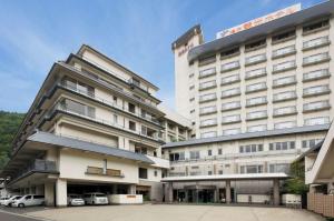 a large hotel with cars parked in front of it at Naruko Kanko Hotel in Osaki +19 photos