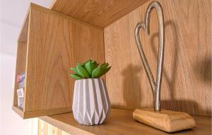a vase with a plant on a shelf next to a knife at Blumenwiesenweg 17 in Untergriesbach