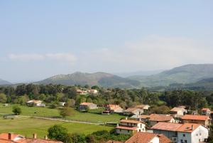 un petit village avec des montagnes en arrière-plan dans l'établissement Hosteria El Corralucu, à Serdió