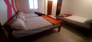 a small bedroom with a bed and a window at ROYAL GRAND Homestay & Resort in Vālpārai