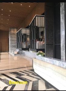 a lobby of a hotel with a building with windows at Apartemen springwood in Kebun Nanas
