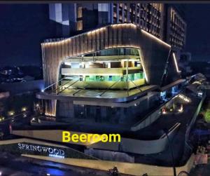 a building in a city at night with the words began at Apartemen springwood in Kebun Nanas
