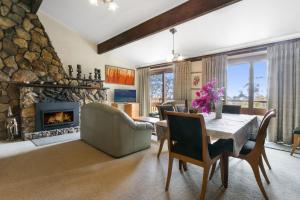 a living room with a table and a fireplace at Solitary View in Wentworth Falls