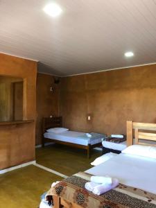 a room with two beds in a room with a ceiling at Recanto do Vale in Pirenópolis