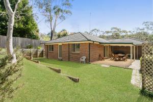 ein Backsteinhaus mit einer Terrasse und einem Hof in der Unterkunft Minnehaha in Katoomba