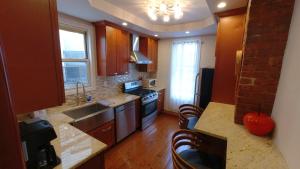a kitchen with a sink and a stove top oven at El Edén 2 Bedroom with parking Space close to hospital in Parkchester