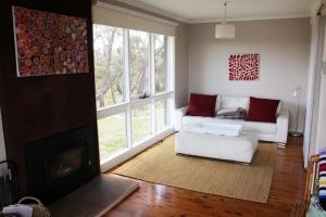 a living room with a couch and a fireplace at Highview in Leura