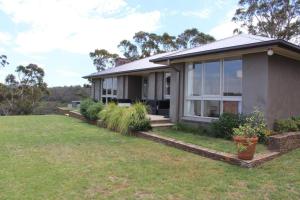a house with a lawn in front of it at Highview in Leura