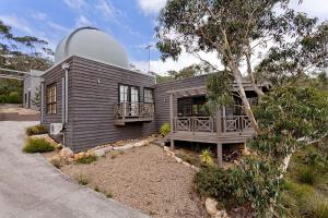 a small house with a observatory on top of it at Observatory Cottage in Leura
