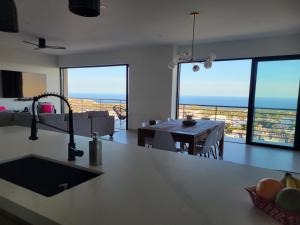 a kitchen and living room with a view of the ocean at Casa Sola Penthouse in Cabo San Lucas