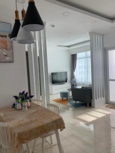 a living room with a table and a couch at Ocean Dream Apartment Nha Trang in Nha Trang