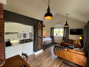 a kitchen and living room with a couch and a bed at The Studio at Northfield in Methven